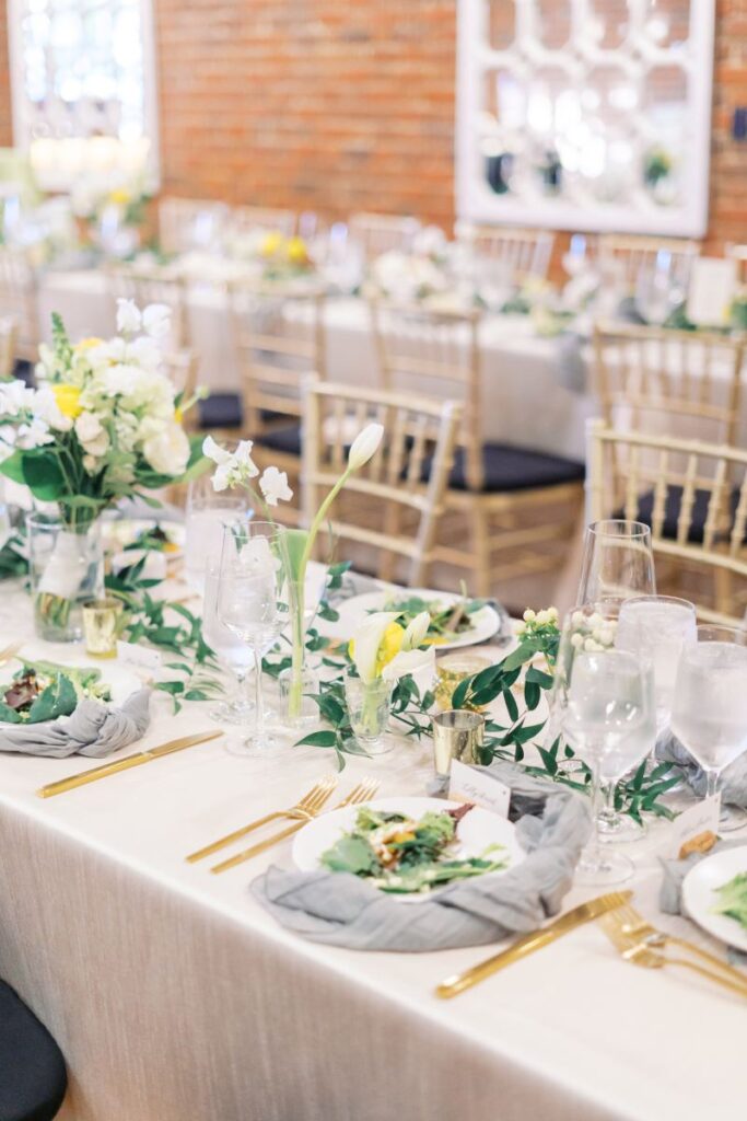 Reception tablescape with florals and candles, highlighting details captured during wedding day coverage